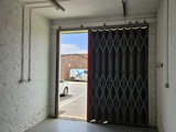 Inside an industrial unit, looking out the front entrance